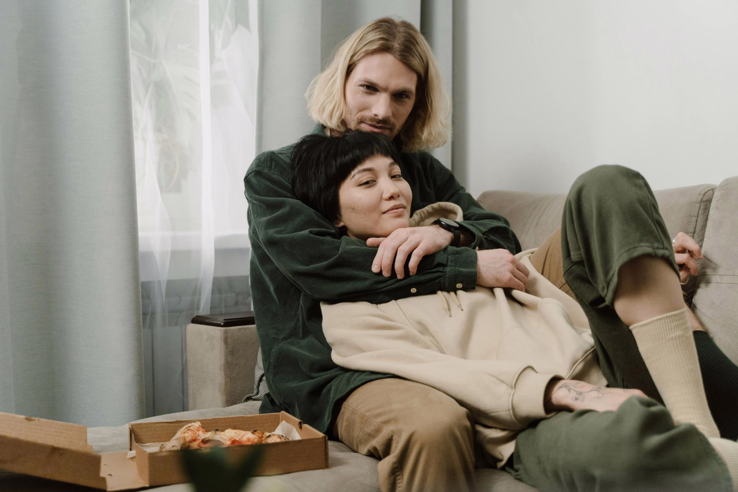 Mindful Couple Sharing a Moment of Connection A couple sitting on a couch, phones set aside, connecting with each other and smiling